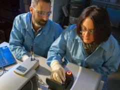 LNL researchers Nick Fischer and Amy Rasley are characterizing nanolipoprotein particle vaccine formulations using a dynamic light-scattering instrument. The researchers are part of a team developing one vaccine to protect U.S. forces against three different bacterial biothreats. Credit: Julie Russell/LLNL