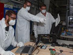 LLNL mechanical engineer Ken Enstrom (l) and technicians Greg Norton (c) and Aaron Sperry test and validate simple ventilator prototypes that could be easily assembled from readily available parts. Photo by Julie Russell/LLNL