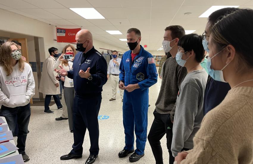 General Jay Raymond and Astronaut Col Nick Hague talking to students in December 2021 about their experience building a satellite.