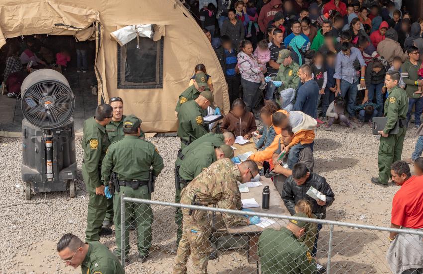 U.S. Customs Border Patrol (CBP) agents provide food, water and medical screenings to migrants at a processing center. Many immigrants often surrender to CBP agents upon crossing the U.S.-Mexico border for help and safety. Credit: Mani Albrecht, U.S. Customs and Border Protection Office of Public Affairs–Visual Communications Division