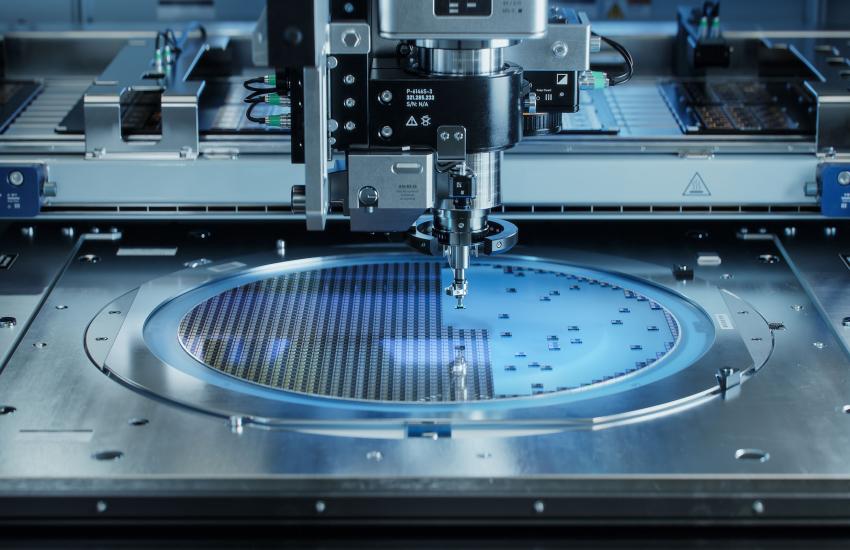 A pick-and-place machine extracts silicon dies as part of the computer chip manufacturing and packaging process. Credit: IM Imagery/Shutterstock