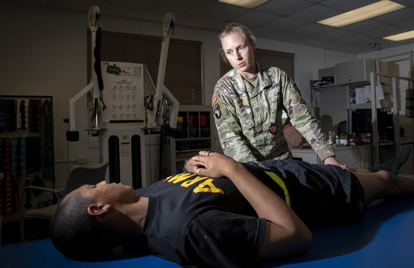 An Army physical therapist treats a soldier at the Fort Sam Houston physical therapy clinic. To support the DHA’s nine medical centers, 36 hospitals, 525 clinics and 138 dental facilities worldwide, the agency must rely on innovative medical information technology, leaders say. Credit: DHA photo by Jason Edwards