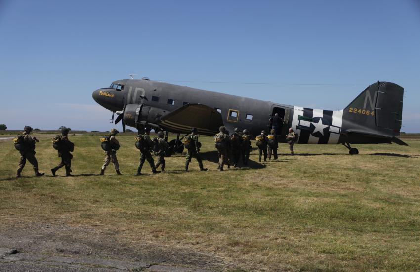 Reenactors board the aircraft.