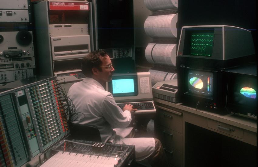 Technological evolution: When he came to NIH in 1970, Dr. Richard Coppola introduced computers to his National Institute of Mental Health (NIMH) laboratory, drastically reducing the time needed to do experiments. Now, as director of the NIMH MEG (Magnetoencephalography) Core Facility, he provides NIH researchers with a noninvasive method to study brain function. Photo taken in 1983. Credit: National Institutes of Health