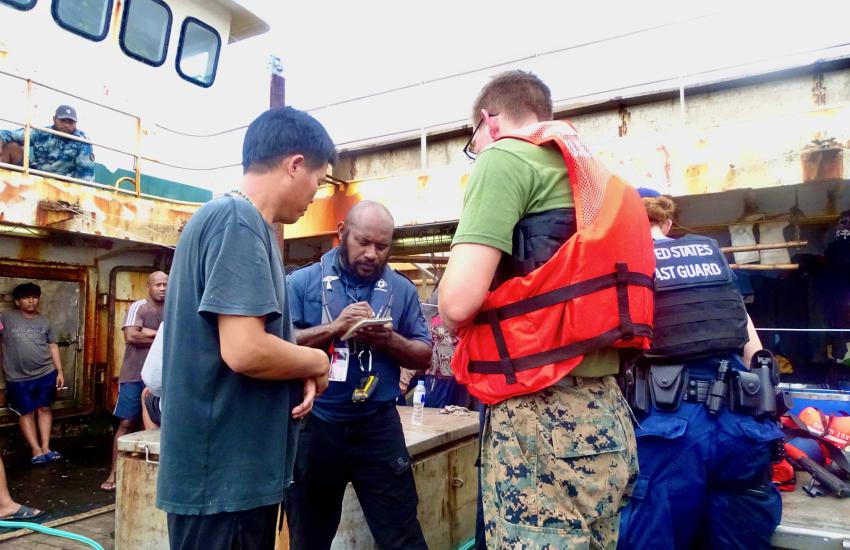 The USCGC Frederick Hatch conducts fisheries boardings in the Palau exclusive economic zone and addresses a Philippine crew using translations on a tablet. Credit: U.S Coast Guard