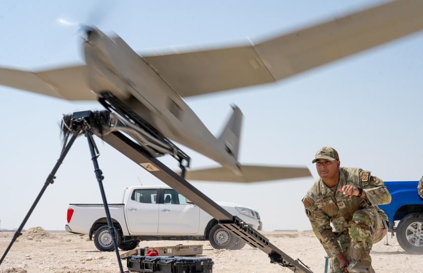 An operator launches an RQ-20B Puma drone within the U.S. Central Command area of responsibility. This system has secondary GPS for control during flight.