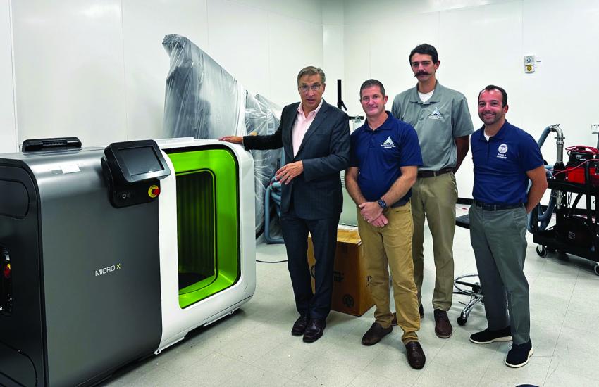 A possible self-service carryon luggage screening solution could have passengers inserting their suitcases into the device and walking through an advanced passenger screener technology, paired together, which could speed up the whole security process, says Lab Director Christopher Smith, standing with David Preissman, test engineer, Developmental Test and Evaluation Division; John Jasinkski, test engineer, Independent Test and Evaluation (IT&E) Division and David Giambri, IT&E test engineer.