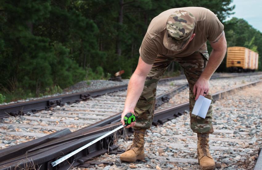 Staff Sgt. Jason Walker, a rail advisor, inspects a rail frog, an intersection of two rail lines where trains can switch tracks, at Joint Base Langley-Eustis, Virginia. Credit: Sgt. Therese Prats, U.S. Army