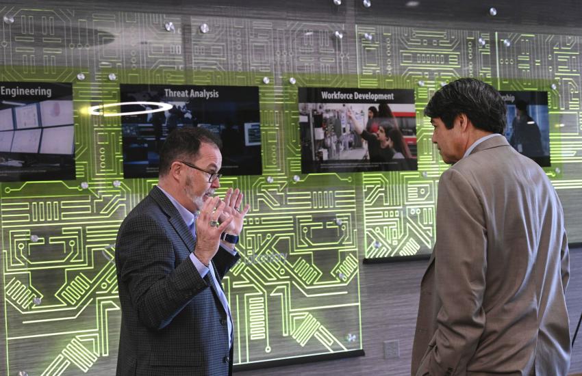 Scott Cramer, Cybercore Integration Center director, speaks with Gene Rodrigues, assistant secretary of electricity, Department of Energy. The Cybercore Integration Center specializes in cybersecurity for industrial control associated with U.S. critical infrastructure.