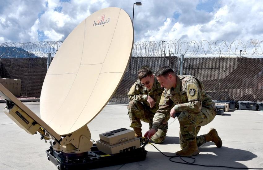 Spc. Klay Walker (l) and Spc. Alexander Best with the 4th Space Company, 1st Space Battalion, establish expeditionary communications with a 1.2 meter Hawkeye antenna at Fort Carson, Colorado, September 2023. U.S. Army photo by Dottie White
