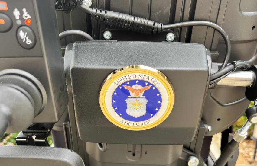Rick Lipsey's motorized wheelchair is decorated with the U.S. Air Force emblem.