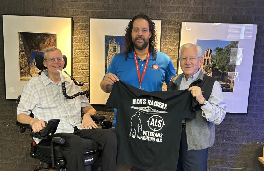 Rick Lipsey (far left) and Chris Cook (far right) share a Rick's Raiders T-shirt with KSAT-TV.