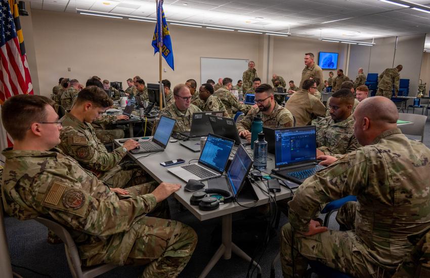 Service members from the 175th Cyberspace Operations Group at Martin State Airport and Fort Meade and the Maryland Army National Guard Cyber Protection Team 169 work in teams to compete in the 175th Cyberspace Operations Group Capture the Flag event, December 2025, at Martin State Air National Guard Base, Maryland.  U.S. Air National Guard photo by Staff Sgt. Laura Virtue