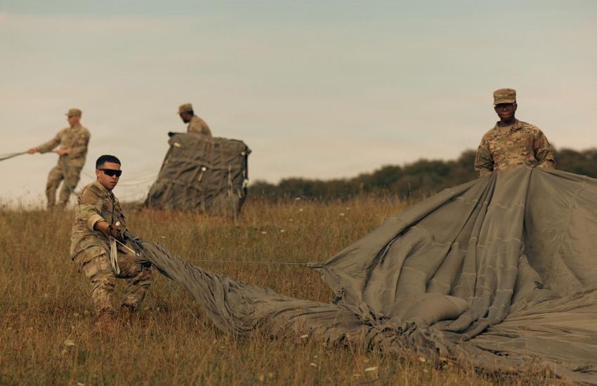 U.S. Soldiers with the 173rd Mobile Brigade Combat Team gather parachutes following an aerial resupply drop during exercise Saber Junction 26 at the Joint Multinational Readiness Center’s Hohenfels Training Area in Germany in August. Credit: Pfc. Aubrey Boyle