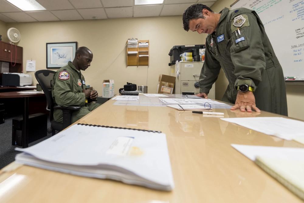 U.S. Air Force Lt. Col. David Martinez (r) conducts a pre-flight brief with Lt. Col. Alex Edwards, both from the 125th Fighter Wing, during Onramp 2 of the Advanced Battle Management System in 2020. Now that the service has completed the proof-of-concept for AMBS, the Air Force is creating a sophisticated battle management model to help inform requirements.