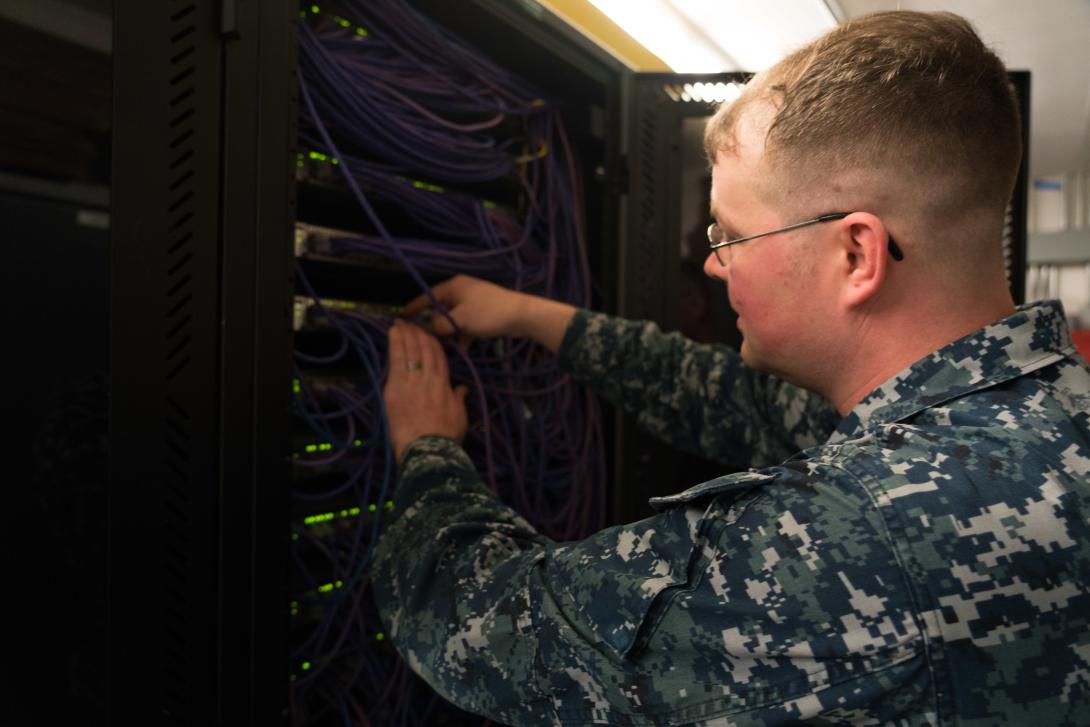 U.S. Navy Petty Officer 1st Class William Croninworks on network infrastructure. Photo by Maj. Jon Quinlan.