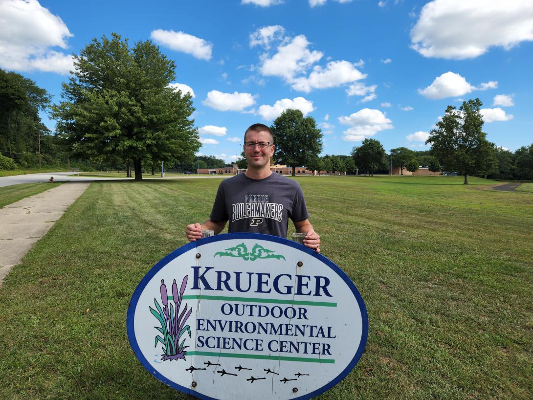 Winner of the AFCEA MG Eugene C. Renzi, USA (Ret.) STEM Teachers Scholarship Kevin Jones poses for a photo taken by his wife, at Krueger Middle School, while also representing the Purdue University Boilermakers football team.