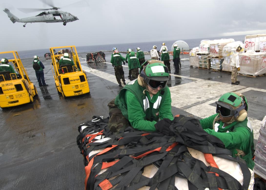 Sailors loosen the netting on a supply pallet aboard the aircraft carrier USS George Washington during a vertical replenishment with the Military Sealift Command. Photo By: Petty Officer 3rd Class Jared Hill, U.S. Navy.