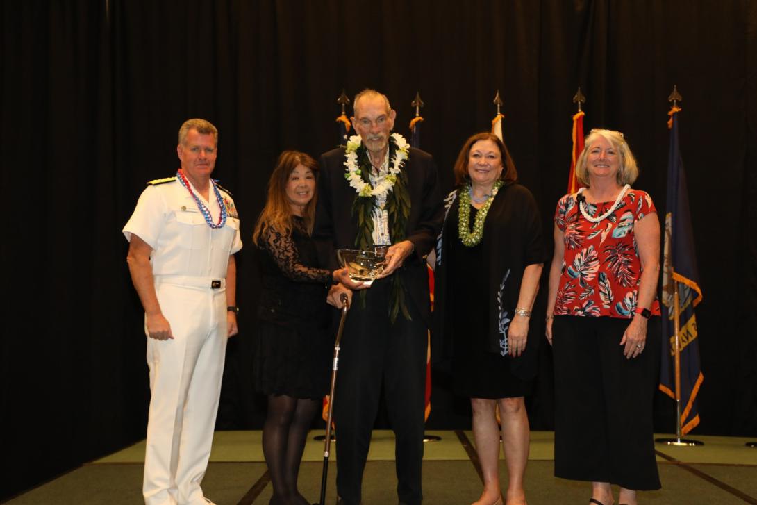 Rear Adm. Richard Macke, USN (Ret.) is honored with an award in April 2022