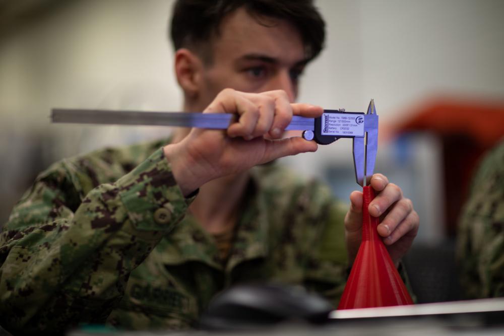 Fireman Dalton Garret, assigned to the USS Bataan Engineering Department, produces a computer-aided draft for a three-dimensional printing project. The USS Bataan sent five engineering department sailors to a 3D-printing course to manufacture objects using newly installed additive manufacturing equipment onboard the vessel. Credit: Mass Communication Specialist 2nd Class Matthew F. Brown, U.S. Navy