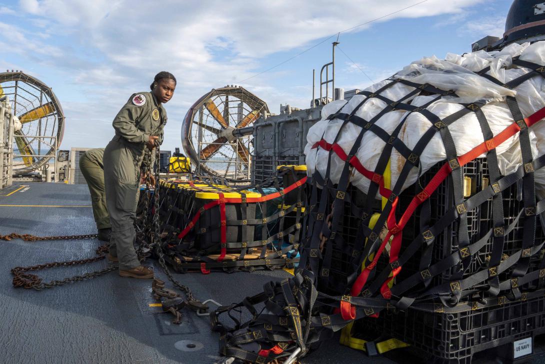Sailors prepare material recovered from a Chinese high-altitude surveillance balloon for transport to federal agents at Joint Expeditionary Base Little Creek, Virginia, during operations in the Atlantic Ocean. Photo by U.S. Navy Petty Officer 1st Class Ryan Seelbach