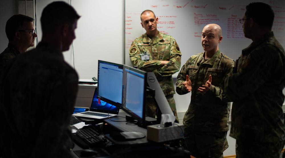 U.S. Air Force Tech. Sgt. Daniel Bowser, 1st Combat Communications Squadron mission defense team (MDT) section chief assigned to Ramstein Air Base, Germany, discusses the integrity of data with other warfighters during the so-called Tacet Venari exercise at Ramstein last May. The Air Force is going to continue its MDT construct. U.S. Air Force photo by Airman 1st Class Jared Lovett