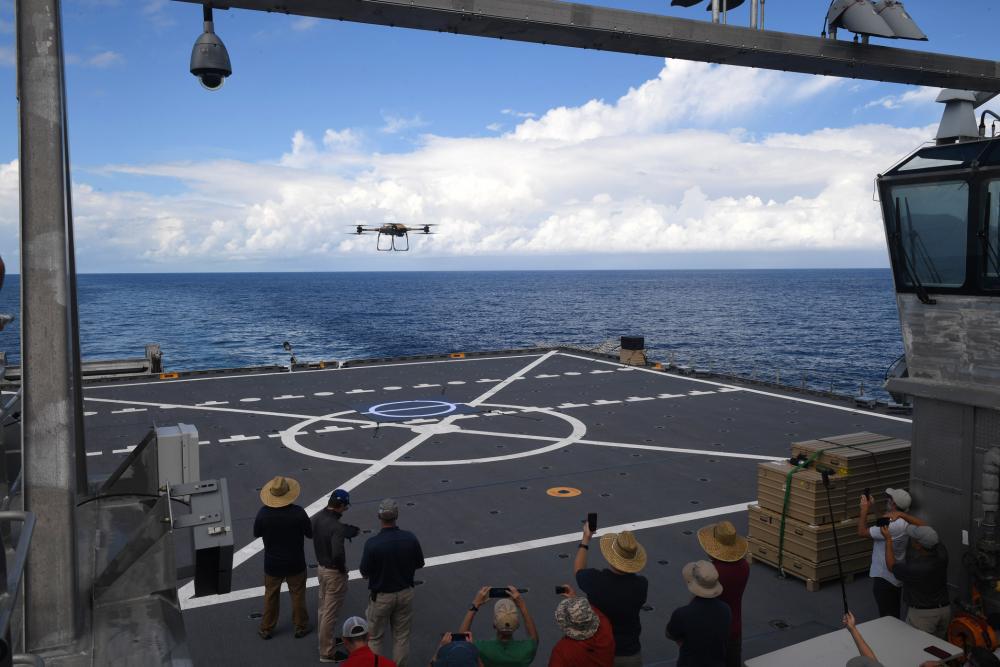 Crewmembers from the engineering company Survice, aboard the Spearhead-Class expeditionary fast transport vessel USNS Burlington (T-EPF-10) land the Tactical Resupply Vehicle (TRV) 150 unmanned aerial system practice landing on the ship autonomously amongst onlookers from the Scientists-to-Sea program underway during the Navy’s Fleet Experimentation Program, Oct. 17, 2022. The event was organized by the Office of Naval Research-sponsored SCOUT initiative and U.S. Fourth Fleet, held in Key West, Florida.