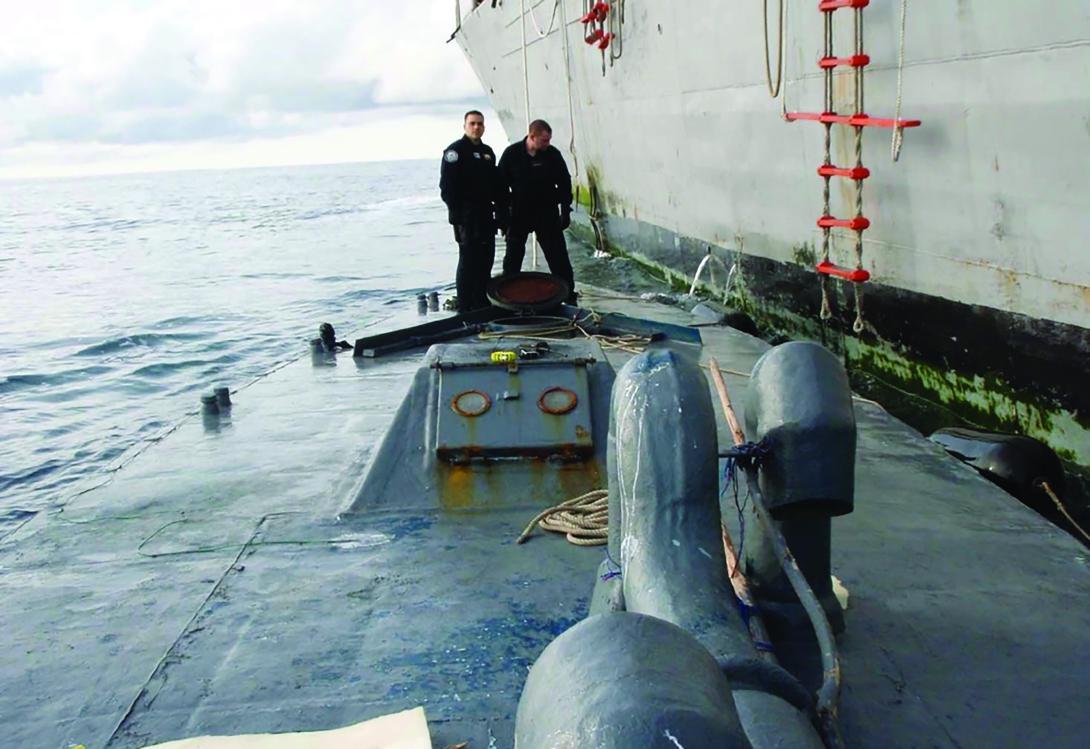 U.S. Coast Guard members on the deck of the self-propelled, semisubmersible craft they seized in 2008. The estimated street value of the cocaine was more than $187 million at the time. This seized vessel had the capability to travel from Ecuador to San Diego. Credit: Petty Officer 1st Class Nico Figueroa, U.S. Coast Guard