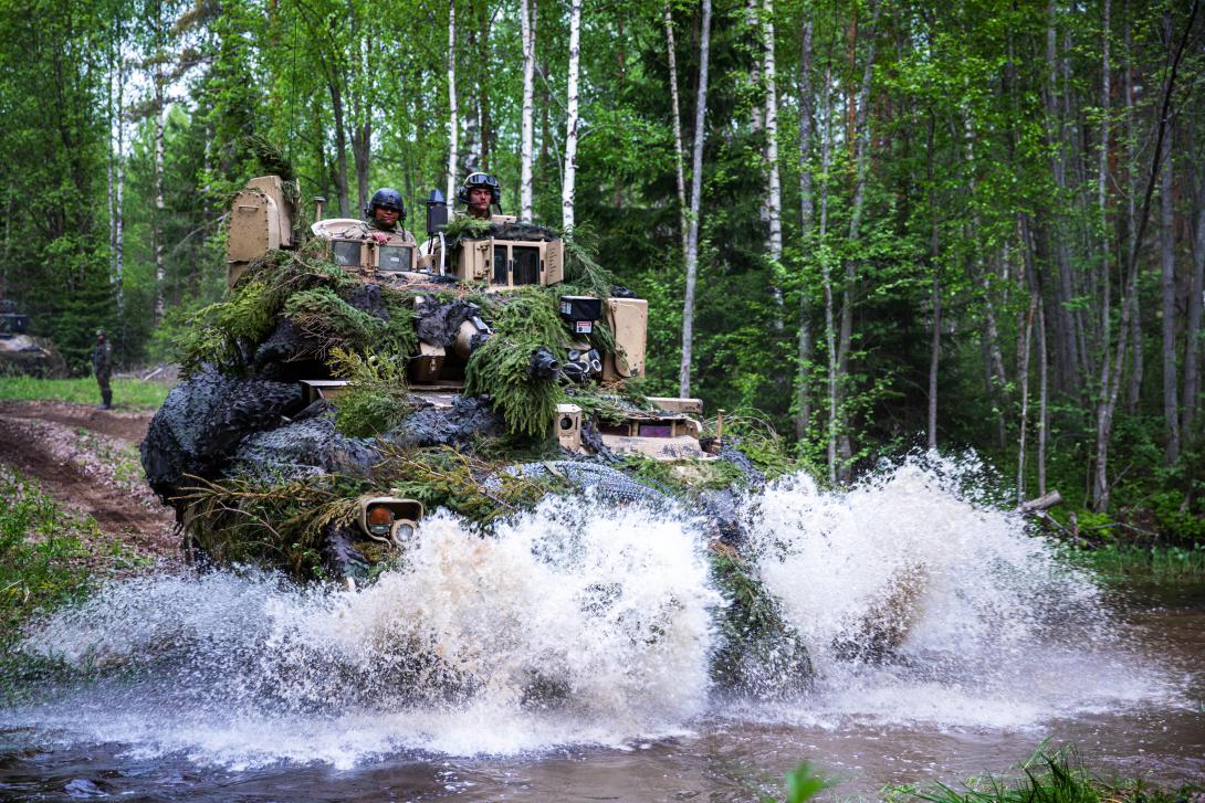 Soldiers navigate a Bradley fighting vehicle through the battlefield during Karelian Lock 23 in Pahkajarvi Training Area, Finland, last month. The Bradley will be replaced by the XM30 Mechanized Infantry Combat Vehicle, an optionally-manned armored vehicle.   Army Sgt. Brayton Daniel