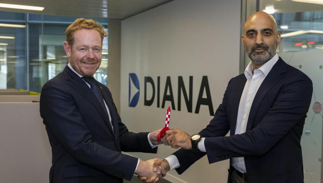 NATO’s assistant secretary general for Emerging Security Challenges, David Van Weel, symbolically passes the “baton” to DIANA’s managing director, Deep Chana in London. Credit: NATO