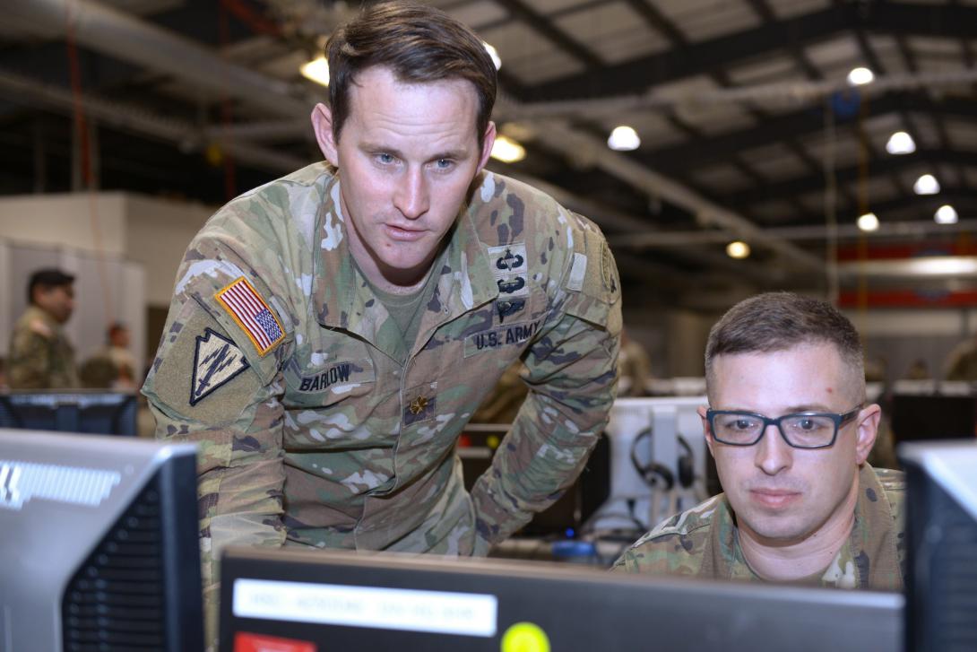 Indiana National Guard soldiers with the 38th Infantry Division, Maj. Adam Barlow, operations chief from Shelbyville, and Capt. Justin Shutt, battle captain from Fort Wayne, monitor a simulated battle during the division’s command post exercise at Camp Atterbury near Edinburgh, Indiana, in February. The Unified Network is foundational to Army modernization efforts. Credit: Master Sgt. Jeff Lowry