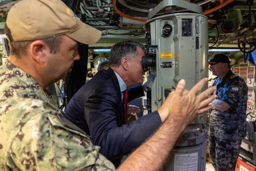 Australian deputy prime minister Richard Marles looks through the periscope of the USS Asheville while moored in Western Australia in March 2023. Credit: Australian Department of Defense.
