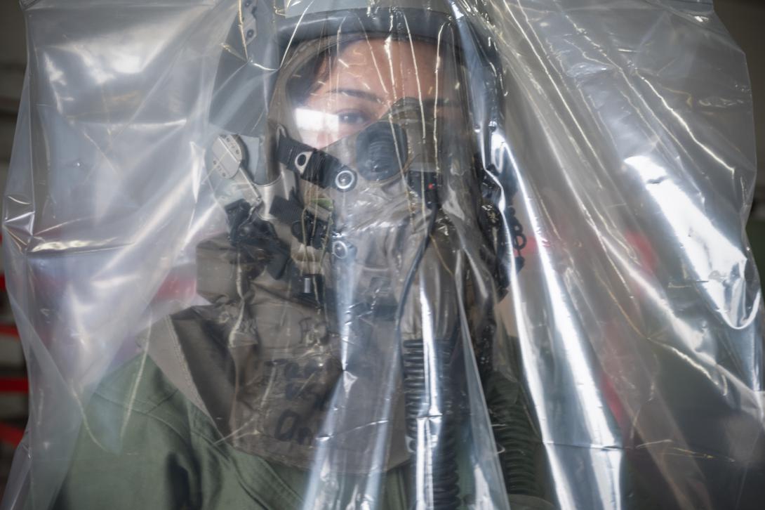 A U.S. Air Force airman uses an over-cloak that provides an extra layer of protection during a demonstration in Hawaii, showcasing the F-22 aircrew chemical, biological, radiological and nuclear limiting factor. Credit: Master Sgt. Mysti Bicoy, U.S. Air National Guard