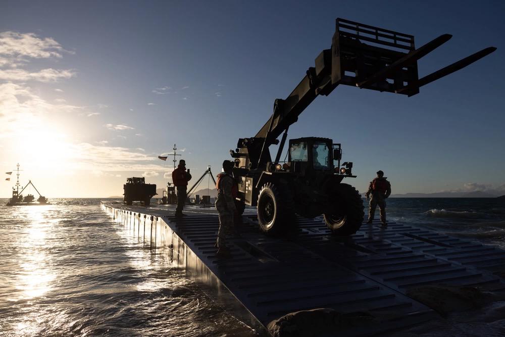 U.S. Army soldiers land equipment on the beach from a floating causeway in Bowen, North Queensland, Australia on July 31 during Exercise Talisman Sabre. The effort was part of the  Joint Logistics Over the Shore activities that enables the movement of equipment, machinery and vehicles to support theater military operations. The Army’s I Corps created dispersed command and control nodes to connect decision making and data around the globe for the exercise.