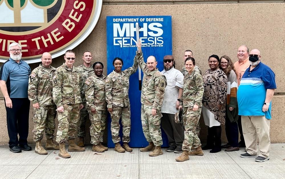 Soldiers and civilian personnel at Bayne-Jones Army Community Hospital celebrate the rollout of the Military Health System’s modernized electronic health record platform GENESIS. The Solutions Delivery Division at the Defense Health Agency is supporting the agency’s next big effort following the deployment of MHS GENESIS, Digital Front Door, which will allow patients to use their own devices as part of a mobile or at-home health suite of tools. Credit: Jean Graves, Medical Readiness Command