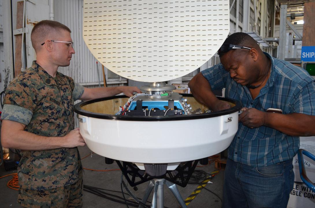  Military and civilian technical experts from Program Executive Office, Command, Control, Communications, Computers and Intelligence inspect a portable Doppler weather radar. Credit: Dawn Stankus, U.S. Navy