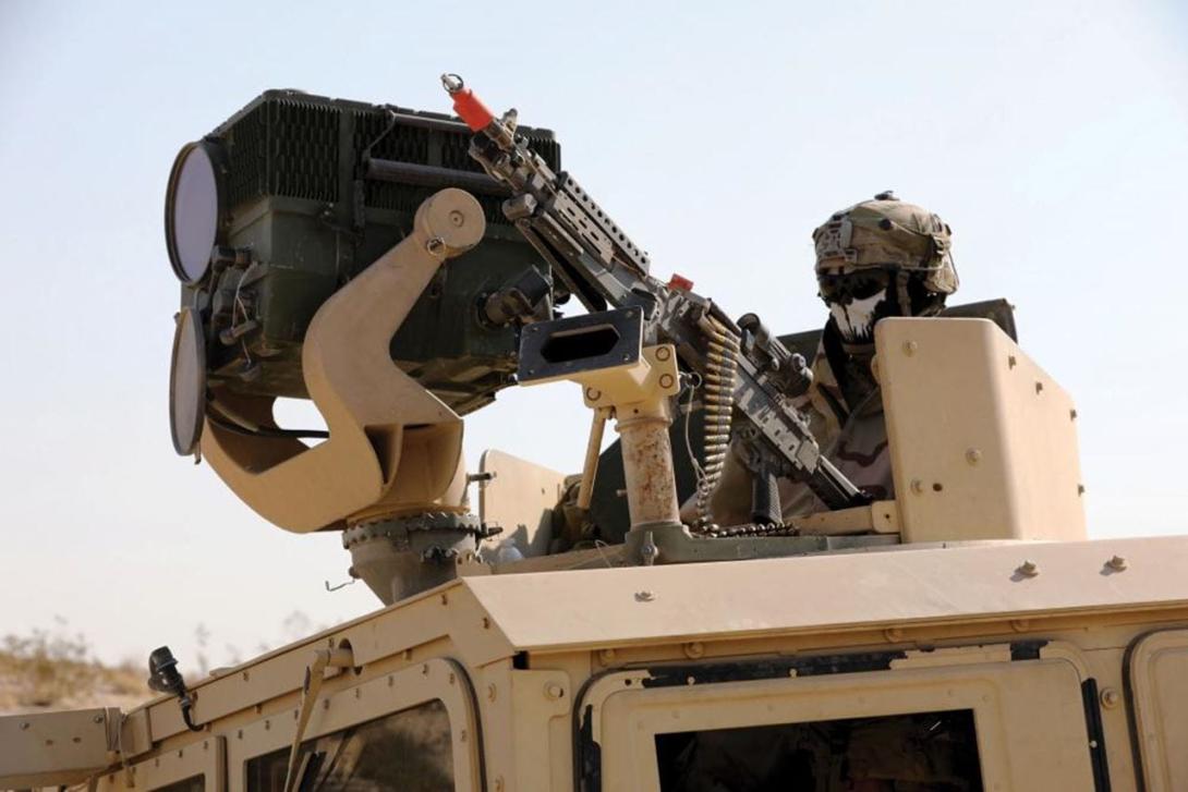 A U.S. Army soldier watches over tanks in his unit with a Long Range Scout Surveillance System equipped with a third-generation forward looking infrared technology at the National Training Center, Fort Irwin, California.