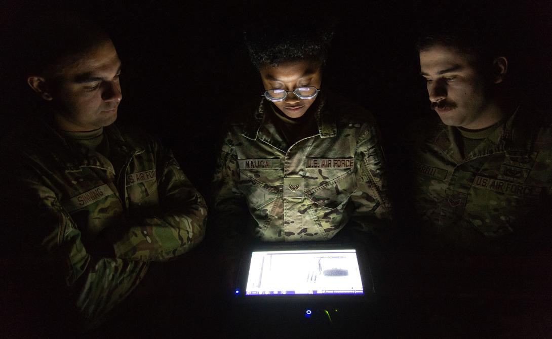 436th Civil Engineer Squadron Explosive Ordnance Disposal technicians (l-r) Senior Airman Kevin Sinning, Airman 1st Class Ariana Nalica and Senior Airman James Verrelli, look at the X-ray of an improvised explosive device taken during a training session at Dover Air Force Base, Delaware, in October 2023. A portable X-ray device wirelessly sends the image to a display tablet for viewing and analysis.   U.S. Air Force photo by Roland Balik