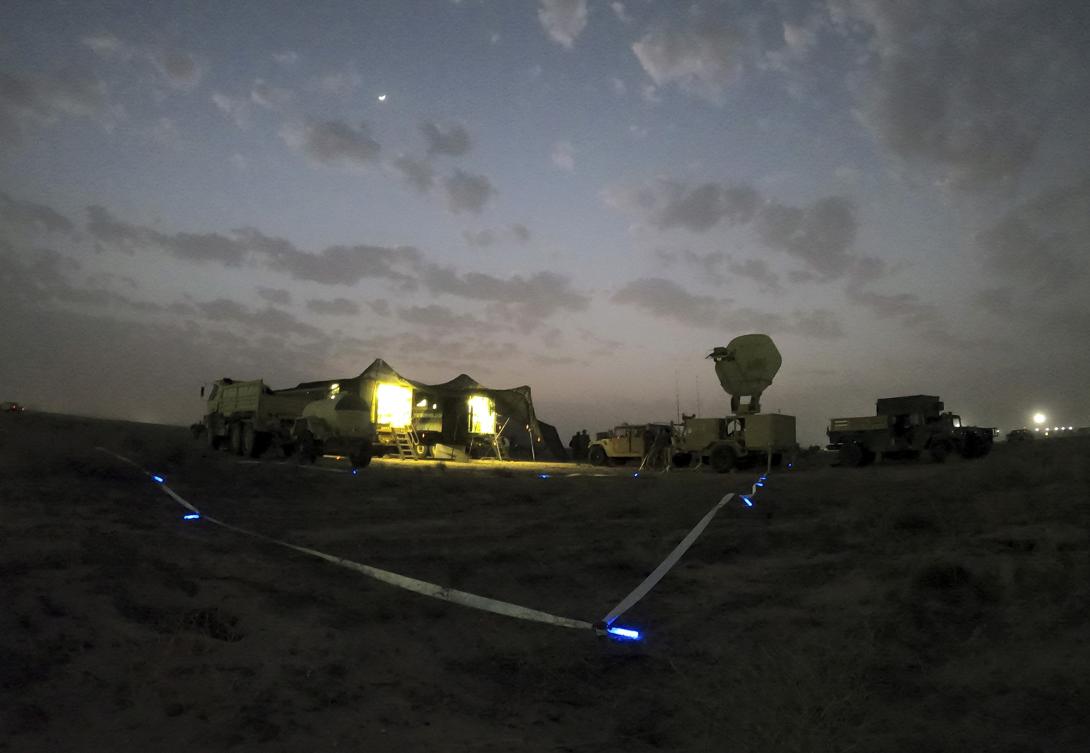 Soldiers work to establish network connectivity in M1087 expandable van shelters during a training exercise at Camp Arifjan, Kuwait, February 4, 2022. Recent network modernization efforts provide greater cybersecurity and improve network speed, reliability and resiliency at Camp Arifjan and at Army Central headquarters at Shaw Air Force Base, South Carolina. Credit: Army Sgt. 1st Class Mary Katzenberger