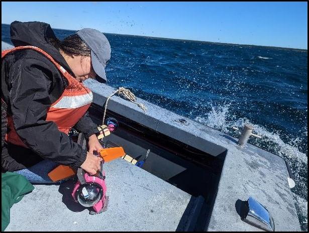 Check out Gabriella Loaiza fixing a micro unmanned underwater vehicle before launch during a Silent Swarm test event on Lake Huron in Michigan.