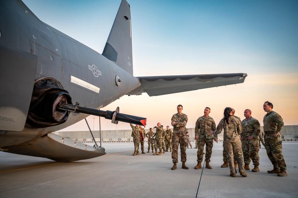 A U.S. Air Force combat systems officer from the 73rd Special Operations Squadron showcases a 105 mm cannon on an AC-130J Ghostrider to other U.S. service members at Al Udeid Air Base, Qatar, June 28, 2023.U.S. Air Force photo by Senior Airman Leon Redfern 