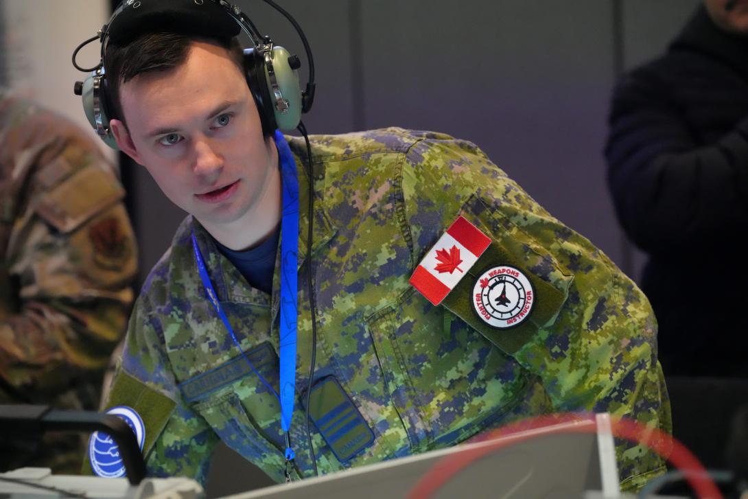 Royal Canadian Air Force Maj. Cody-Jean Carignan leads the multinational Tactical Operations Center-Light cell during the ShOC-N Capstone 24B experiment event at Nellis Air Force Base on December 2-12, 2024. The 805th Combat Training Squadron executed the second of two capstone events developing tactics for integrated two-way kill chain automation between the operational and tactical command and control to create competitive advantages for the United States and its allies. U.S. Air Force photo by Deb Henley