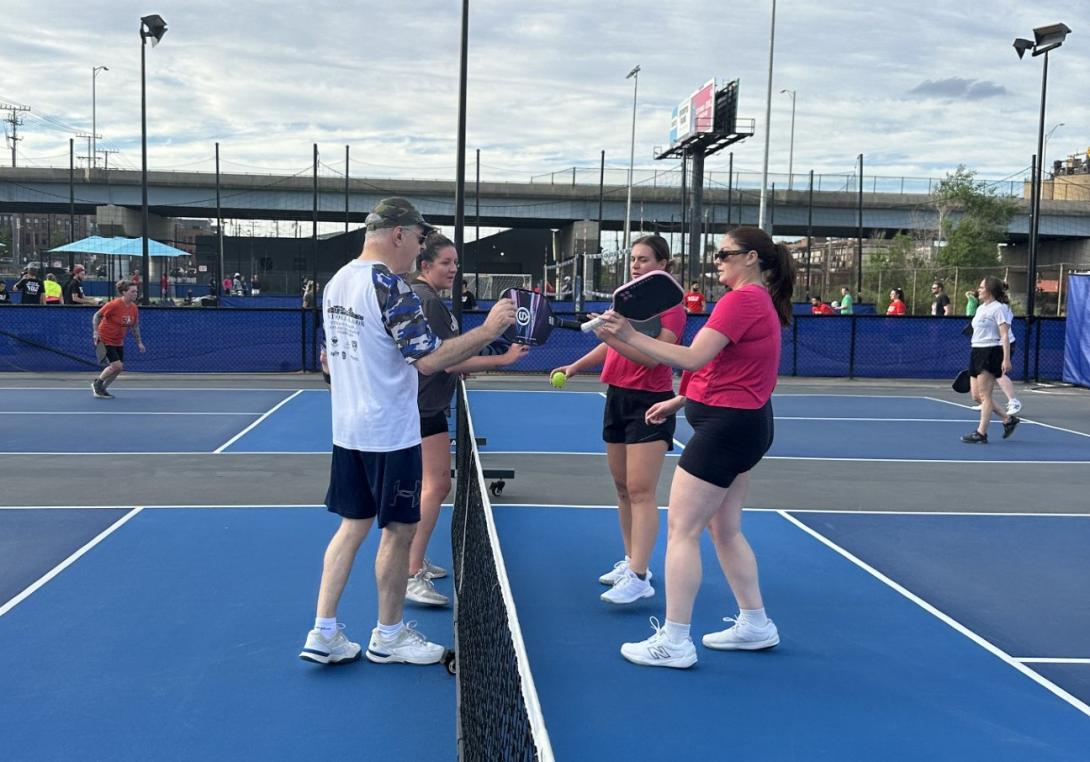 AFCEA's pickleball duos congratulate each other on a well-played match on May 7, 2025, at Club Volo in Baltimore.
