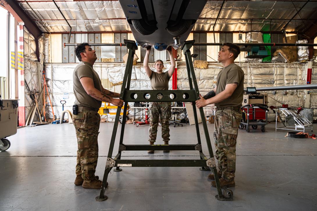 U.S. Army Spc.John De Los Santos (l), Spc. Kylie Chislow (middle), and Spc. Trevor Wagner (r), assigned to Foxtrot Company, 1st Aviation Regiment, 1st Combat Aviation Brigade, part of Joint Task Force - Southern Border, position a MQ-1 Gray Eagle onto a stand at Libby Airfield, Fort Huachuca, Ariz., May 13, 2025. Updated standards for avionics and space-related applications will increase interoperability and security. Credit: U.S. Army photo by Sgt. Chase Murray
