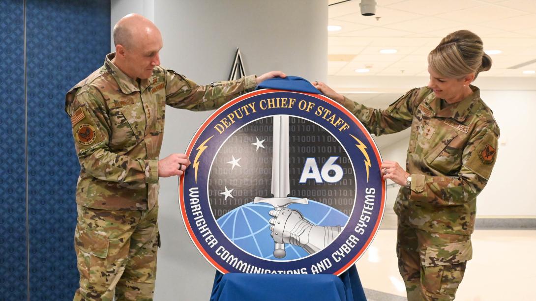 Air Force Chief of Staff General David Allvin (l) and Maj. Gen. Michele Edmondson unveil the new logo for the new A6 office, the Air Force Deputy Chief of Staff Warfighter, Communications and Cyber Systems, at the Pentagon, Arlington, Va., July 23, 2025. According to the Air Force, the creation of the A6 office represents one of the most significant reorganizations of the Air Staff in over 30 years. Credit: USAF photo by Staff Sgt. Stuart Bright