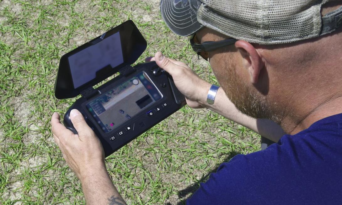 A member of the National Geospatial-Intelligence Agency’s Warfighter Support Office monitors the real-time data feed as the drone collects data over the Army’s training setup, as part of testing a prototype capability known as the GEOINT AI/ML Based Light-Edge Resilient system, or GAMBLER, during training at Fort Bragg, North Carolina. Credit: Courtesy photo