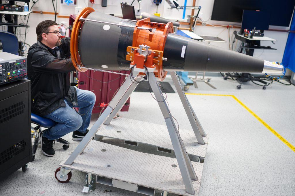 A scientist in April 2025 examines a development cone of the W87-1, the advanced nuclear warhead in development. As lead systems integrator, Sandia National Laboratories’ role in nuclear weaponry spans the entire lifespan of the weapon and requires close collaboration with other labs, plants and sites. Credit: Sandia photo by Craig Fritz