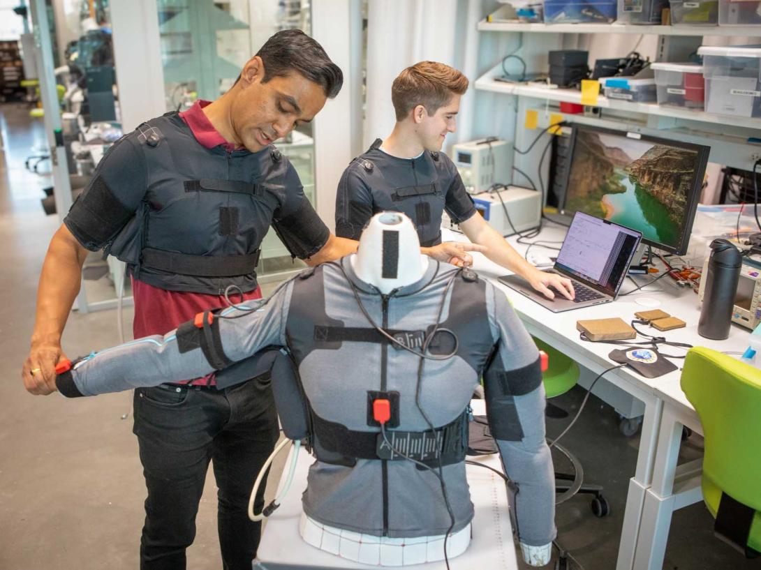 Prabhat Pathak, a postdoctoral fellow at Harvard University, and James Arnold, a Harvard graduate student, conduct research and development on Reachable an artificial intelligence-enabled exosuit that assists with patient shoulder mobility by learning the individual’s movement patterns. Credit: Eliza Grinnell / Harvard SEAS