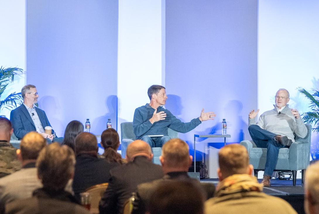 Maj. Gen. Bradley Pyburn, USAF (Ret.) (l), Lt. Gen. Robert Skinner, USAF (Ret.) (c), and Lt. Gen. Chris "Wedge" Weggeman, USAF (Ret.), discuss cyber warfare at the Rocky Mountain Cyberspace Symposium on February 4, 2026. Photo Credit: Zach Watkins, LVTD Digital