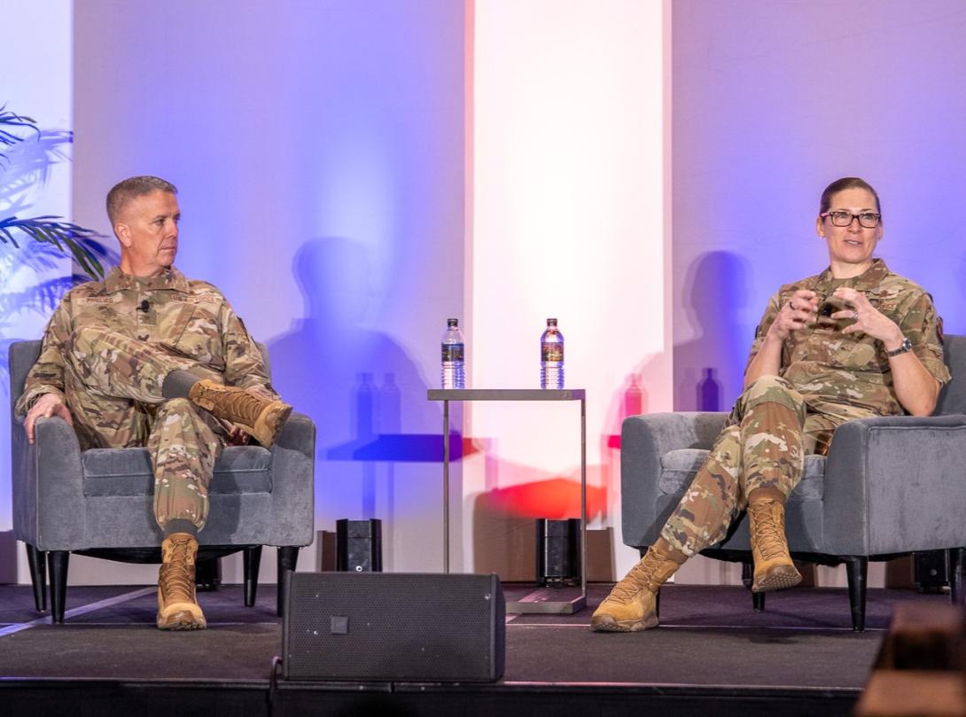Brig. Gen. Jeffrey Phillips, USAF, and Brig. Gen. (select) Lauren Courchaine, USAF, engage in a fireside chat on February 5, 2026, at the Rocky Mountain Cyberspace Symposium 2026. Credit: Zach Watkins, LVTD Digital